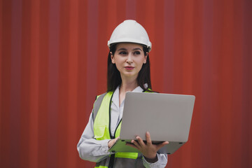 Portrait Caucasian woman with Container box Shipping Logistics Engineering of Import/Export Transportation Industry, Female Safety Transport Engineer holding laptop standing confidently at shipyard.