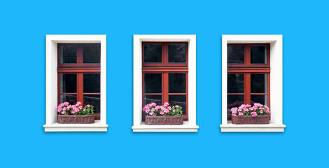 Windows with flower box. Italian architecture background. Vibrant color blue wall facade. Small town house exterior. Street of European city building. Three window frames isolated on empty wall.