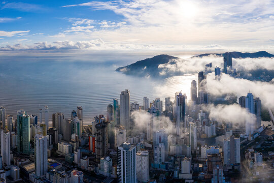 Aerial view of mist covering the city of Bal. Cambori&uacute; early morning, Brazil.