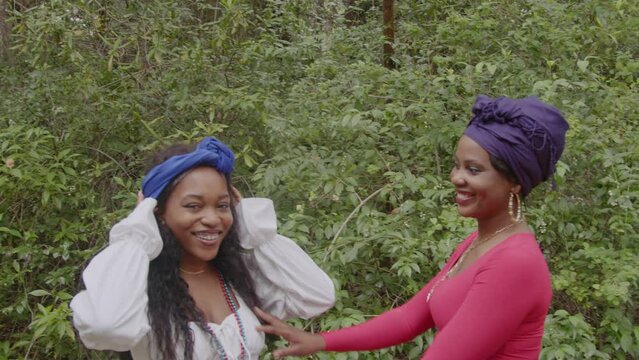 Women joyously putting on headwrap