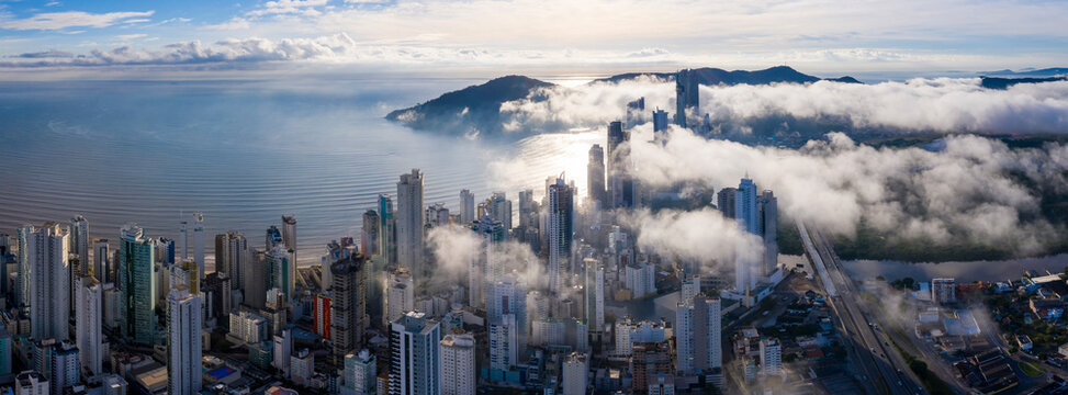 Aerial view of mist covering the city of Bal. Cambori&uacute; early morning, Brazil.