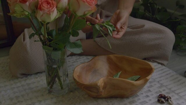 Herbs being put in bowl for spiritual bath