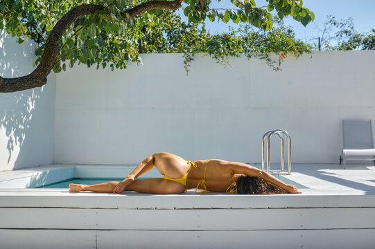 Sporty slim woman relaxing in swimming pool spa