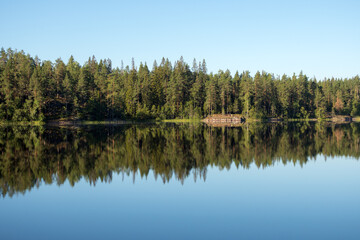 Fototapeta na wymiar symmetrical landscape with reflection on the lake