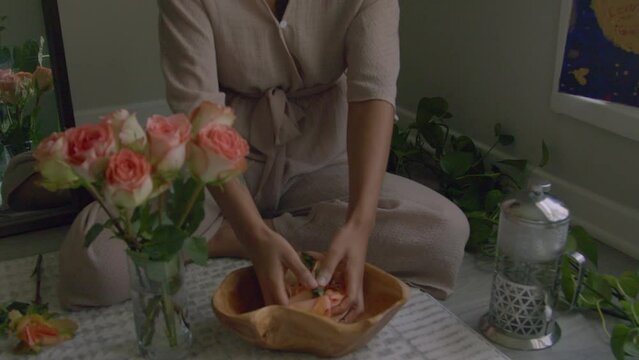 Young woman making floral hand wash
