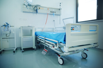 Close-up of empty hospital room with bed.