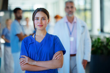 Portrait of young woman doctor at hospital corridor.