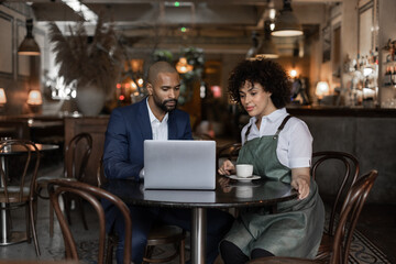 Chef and restaurant owner talking with financial advisor investor