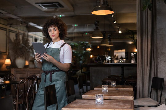 Portrait of restaurant owner holding a digital tablet