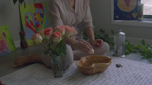 Young woman putting on floral herbal wash