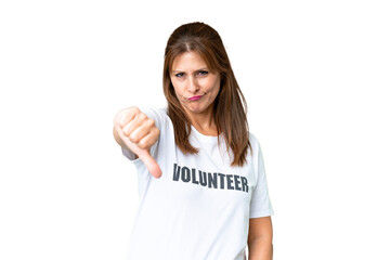 Middle age volunteer woman over isolated background showing thumb down with negative expression