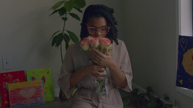 Young woman smelling flowers