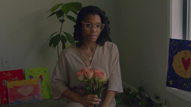 Young woman holding pink roses