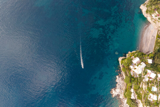 Aerial view of a sailing boat along the Amalfi coast, Salerno, Campania, Italy.