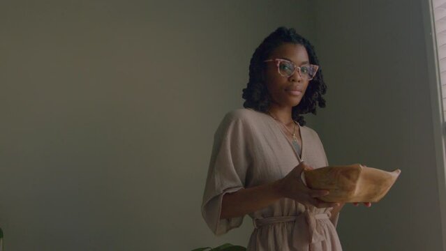 Young woman holding bowl of floral wash