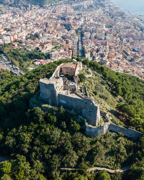 Aerial view of Arechi Castle on mountain top with Salerno downtown in background, Salerno, Campania, Italy.