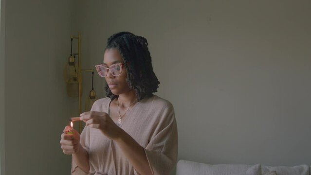 Young woman burning incense