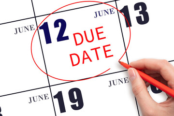 12th day of June. Hand writing text DUE DATE on calendar date June 12 and circling it. Payment due...