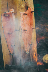Campfire  smoking salmon in pan, near the fire outdoors. bushcraft, adventure, tea, knife and camping concept