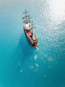 Kemer, Turkey - 13 October 2022: Aerial view of Pirate ship crew swimming.