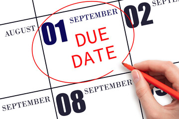 1st day of September. Hand writing text DUE DATE on calendar date September 1 and circling it. Payment due date. Business concept. Autumn month, day of the year concept.
