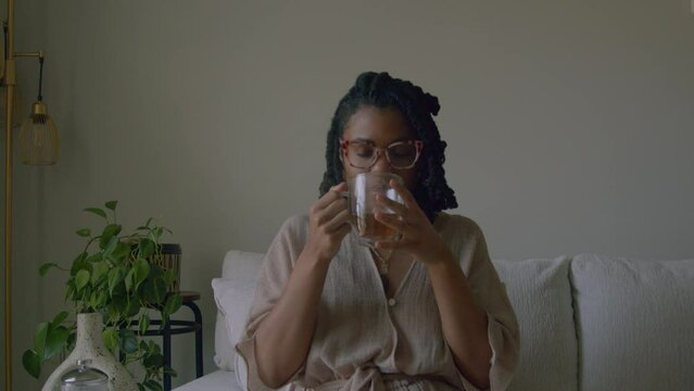 Young woman sipping tea