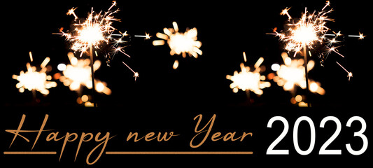 Happy new Year celebration background banner panorama long holiday greeting card - Many sparklers in the dark black night.
