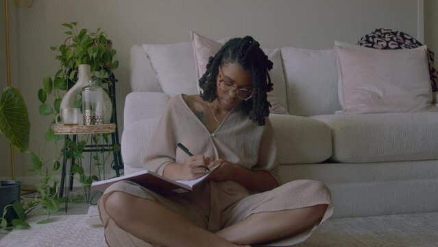 Young woman journaling at home