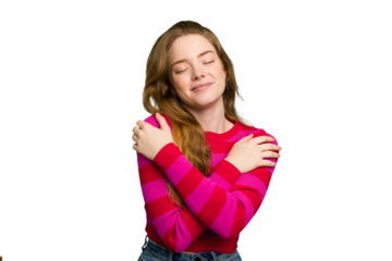 Young caucasian redhead woman isolated hugs, smiling carefree and happy.