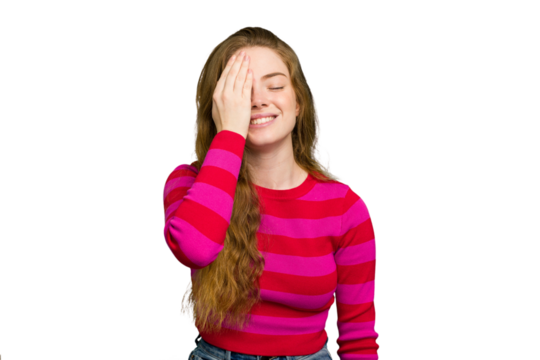 Young caucasian redhead woman isolated having fun covering half of face with palm.
