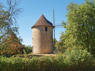 Royal Bastide of Domme. Roy's windmill (Moulin du Roy' at the end of the Public Garden above the old ramparts of Domme Vieille above the Dordogne Valley and the village of Cenac - obrazy, fototapety, plakaty