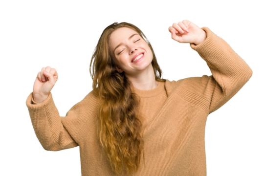 Young caucasian redhead woman isolated celebrating a special day, jumps and raise arms with energy.
