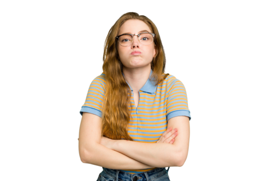 Young caucasian redhead woman isolated blows cheeks, has tired expression. Facial expression concept.