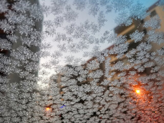 Hoar - frost on a glass with light behind