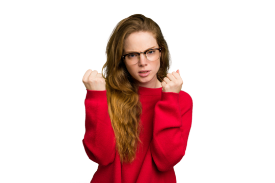 Young caucasian redhead woman isolated showing fist to camera, aggressive facial expression.