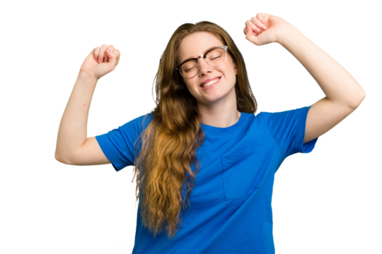 Young caucasian redhead woman isolated celebrating a special day, jumps and raise arms with energy.