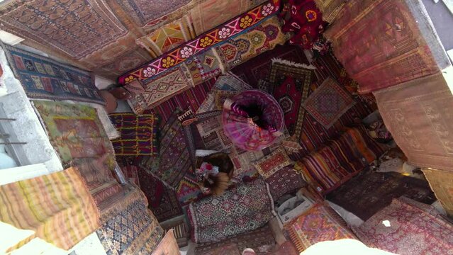 Spinning of Two girls on national carpets of Turkey in Cappadocia