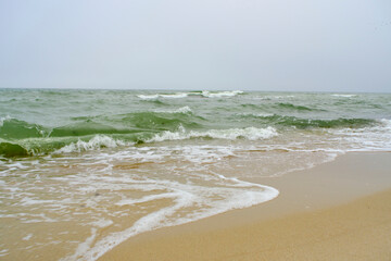 Beach Baltic Sea coast with quartz sand and rolling waves.