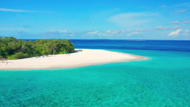 Aerial view of white sand beach and turquoise sea on tropical island Ukulhas, Maldives.