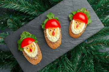 New Year and Christmas sandwiches in the form of Santa Claus from a baguette with cod or pollock...