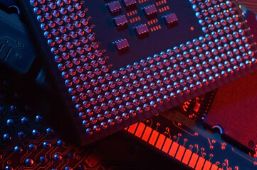 Computer cpu processor chip on circuit board ,motherboard background. Close-up. With red-blue lighting