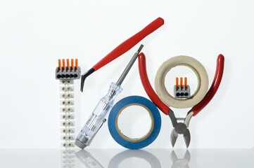 Different tools for electronics repair laid out on a white background