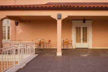Spanish Style Patio in Pink with White Doors and Railing.