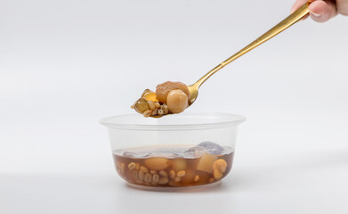 kind of Chinese dessert.  Dessert Ready to eat  in plastic bowl. kind of Chinese dessert with boil sugar syrup is delicious here are many grains.