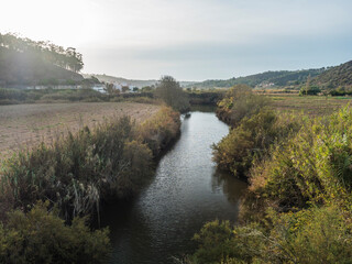 Fototapeta premium View over Rio Seixe river from bridge to village Odeceixe, Alentejo, Portugal