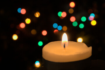 Obraz na płótnie Canvas Christmas candle bokeh coloured lights blurred background