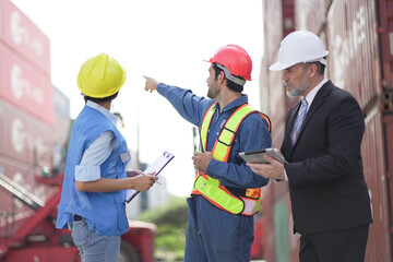 Foreman control loading containers box from cargo freight ship for import export, Business logistic concept, logistics manager. worker container shipment, container port terminal. Import, export Cargo