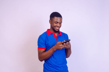 handsome young african man excited about what he saw on his phone