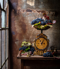 vintage still life, old scales with grapes and wine. beautiful vintage still life.