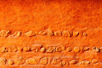 Old orange wall with rocks, scandinavian architecture style background